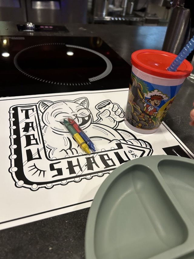 Tabu Shabu kids' coloring placemat with a pack of crayons on the hot pot table